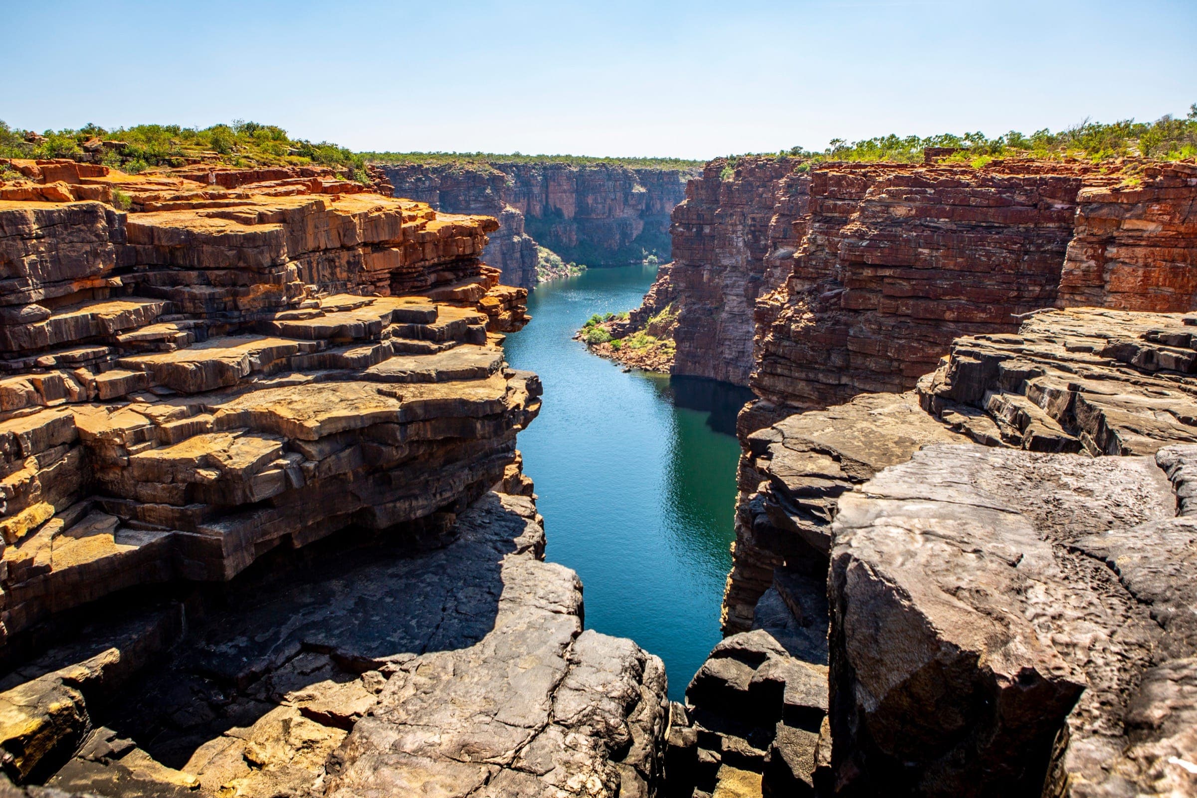 A river gorge made up of a natural formation of flat stone, intricately layered.