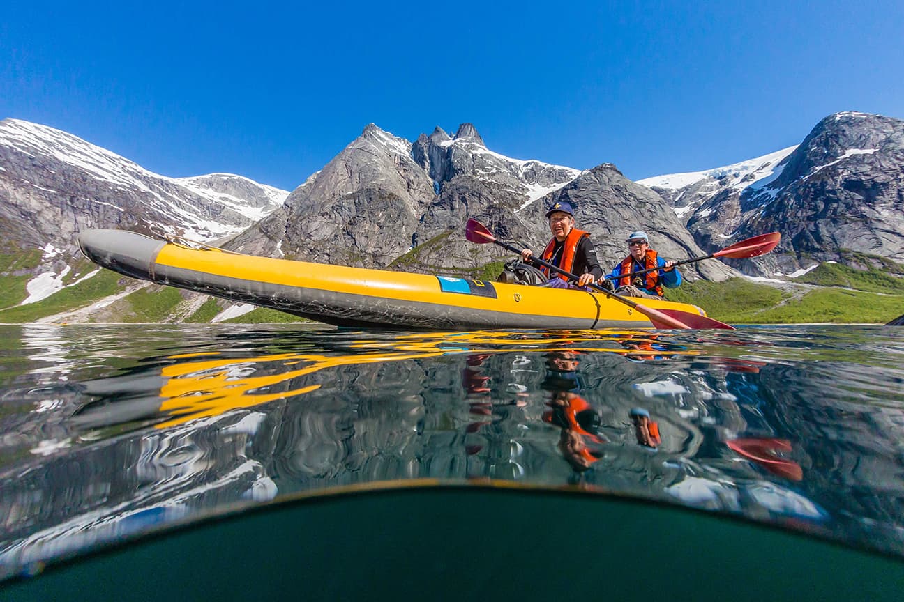 Guests kayak the remote waters of one the many glacier-carved fjords you'll explore throughout Norway. Photo: Michael S. Nolan